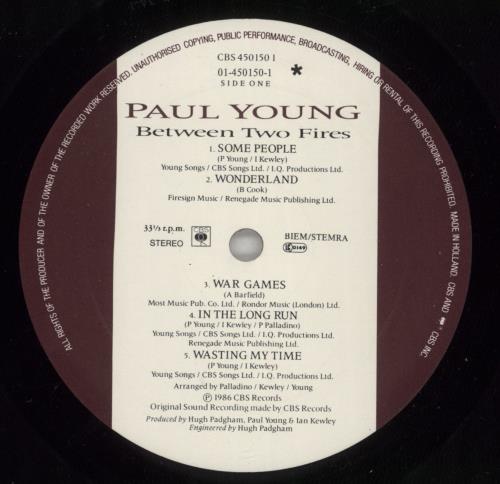 Paul Young Between Two Fires - Autographed vinyl LP album (LP record) UK PYOLPBE874362